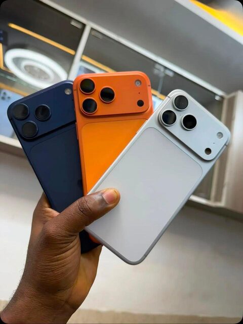 Navy, orange and silver iPhones in hand at the Valmont store